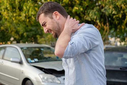 man holding his neck in pain - accidents and injuries photo